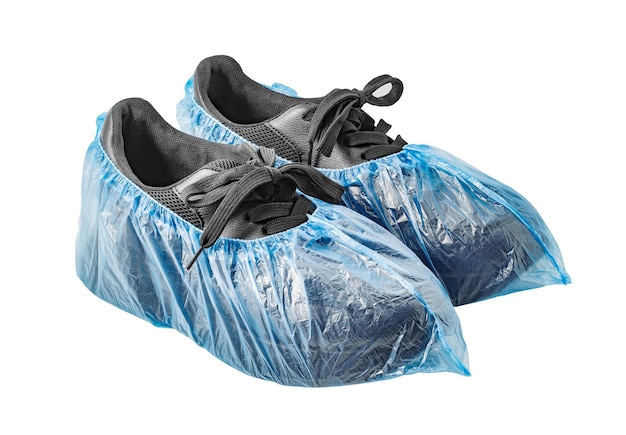 Medical blue shoe covers are worn on black shoes isolated on white background with clipping path