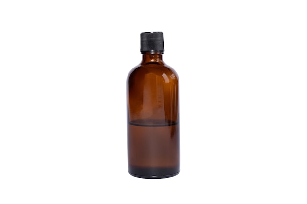 Medical brown glass oil jar with black lid on white isolated surface