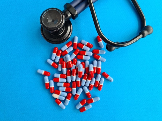 Medical cardiological tablets stethoscope on blue background