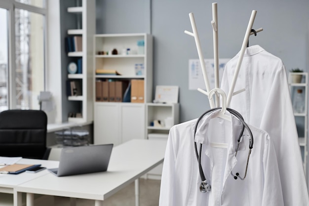 Medical coats and stethoscope in doctors office