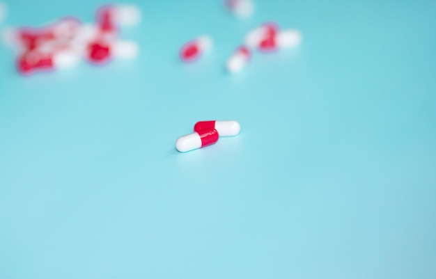 Medical colourful pills on blue background. Health concept. Vitamin.