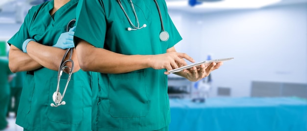 Medical concept operating room doctor holding a tablet