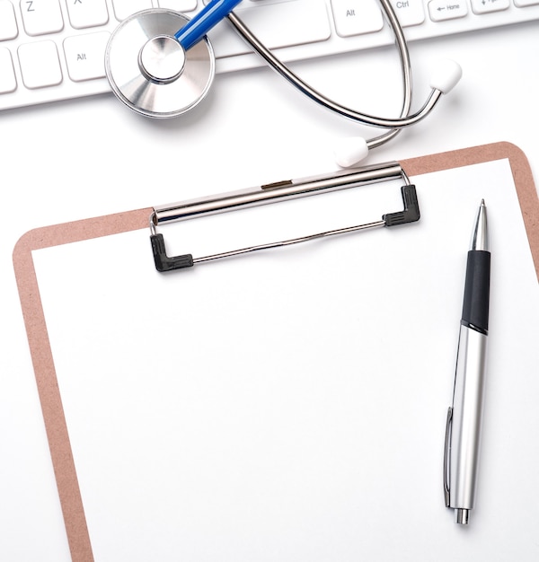 Photo medical concept - stethoscope on computer keyboard on white background