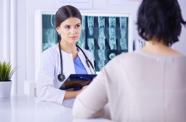 Medical consultation Female doctor holding a patient by her shoulder soothing her fear