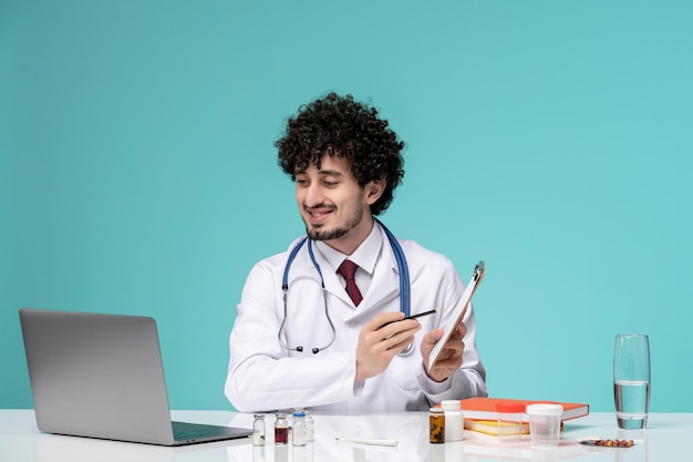 Medical cute handsome doctor working on computer remotely in lab coat explaining prescription