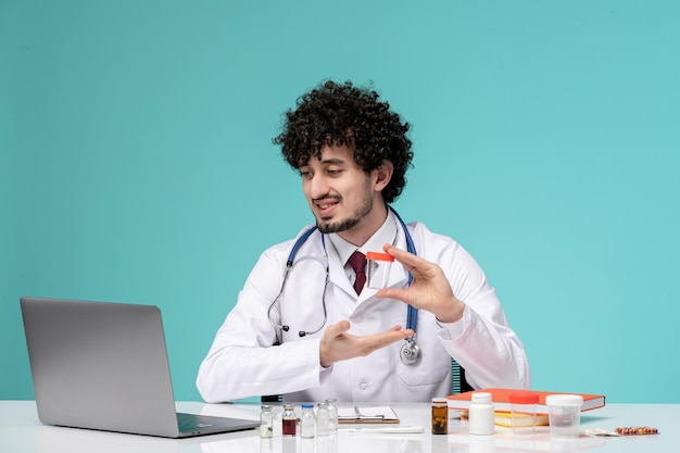 Medical cute handsome doctor working on computer remotely in lab coat holding empty medical jar