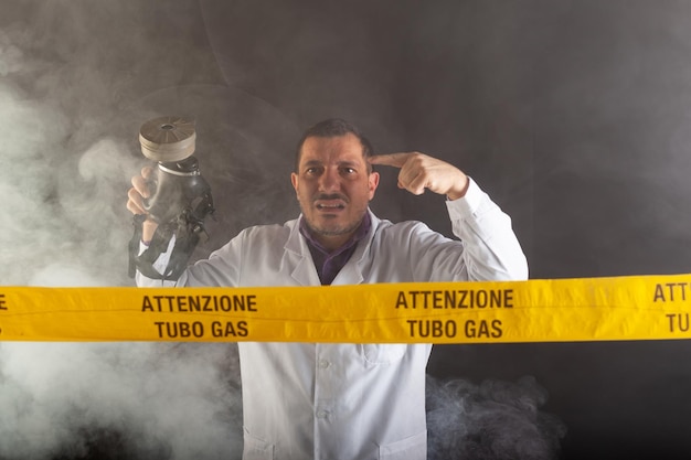 A medical engineer with an antigas mask on his hand directs the emergency in the chaos during the gas leaks