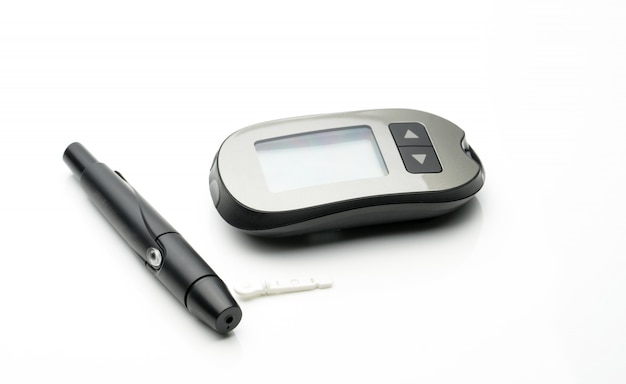 Medical equipment for measuring the level of blood glucose with lancing pen device on white background with copy space