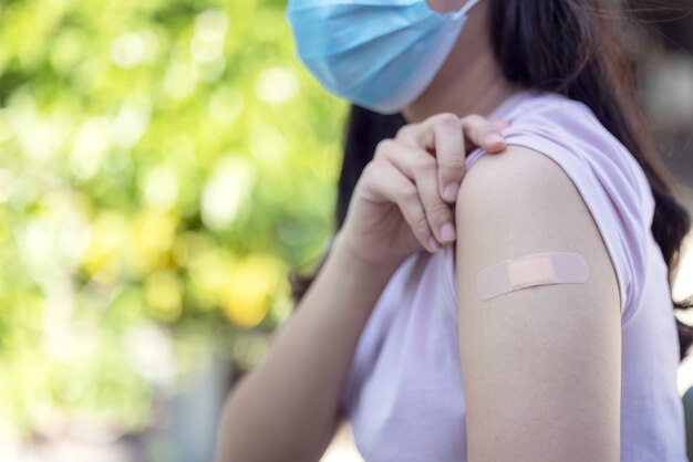 Medical Equipment, Soft focus Adhesive bandage on a female brachium after vaccination against Covid 19. First aid. Medical, pharmacy and healthcare concept.