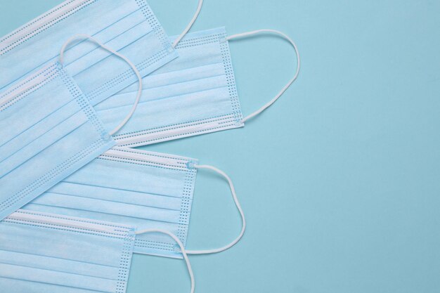 Medical facial masks on a blue background with copy space Top view