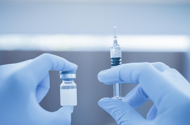 medical hand holding vial vaccine and hypodermic vaccine