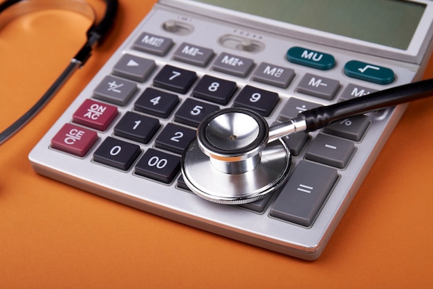 Medical health insurance concept. Accountant's report with stetshoscope, calculator and glasses.