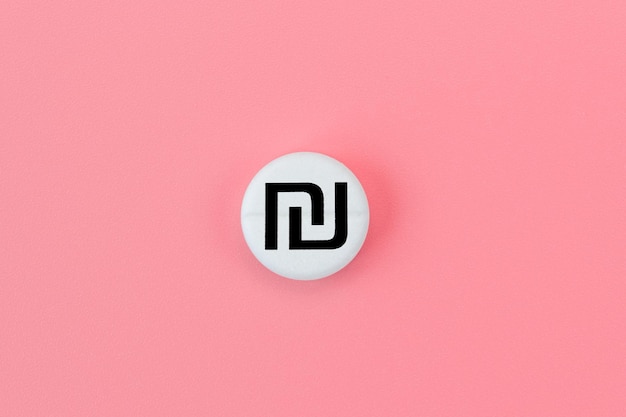 Medical pill with shekel currency sign on a pink background Rise in the price of medicines Expensive medicine in Israel