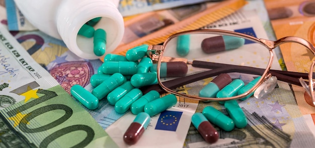 Medical pills tablets in blister with Euro currency banknotes concept of high medical expenses