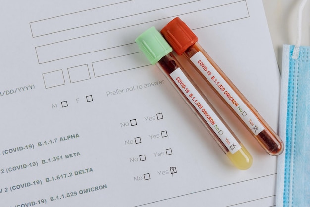 Medical professionals in the laboratory with tube containing blood samples for new version Omicron Covid-19 Coronavirus