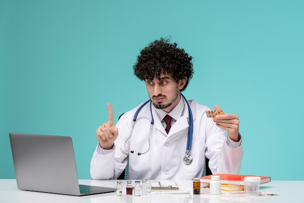 Medical remotely working on computer cute handsome doctor in lab coat asking for a moment