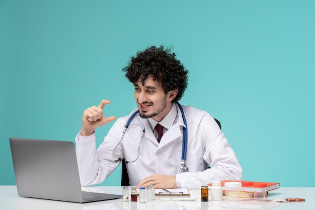 Medical remotely working on computer cute handsome doctor in lab coat wearing stethoscope