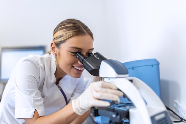 Medical Science Laboratory Beautiful Scientist Looking Under Microscope Does Analysis of Test Sample Young Specialists Using Advanced Technology Equipment