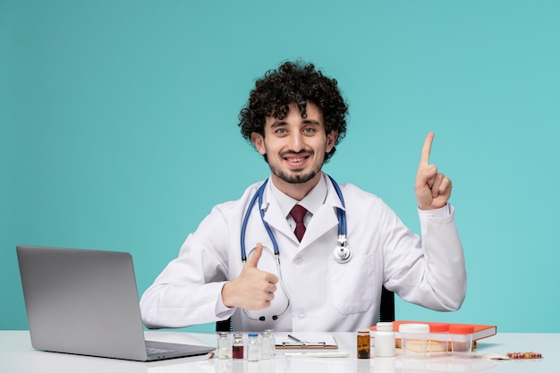 Medical serious cute handsome doctor working on computer in lab coat confident