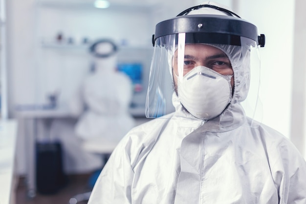 Medical staff wearing protective equipment in laboratory for covid research. verworked researcher dressed in protective suit against invection with coronavirus during global epidemic.