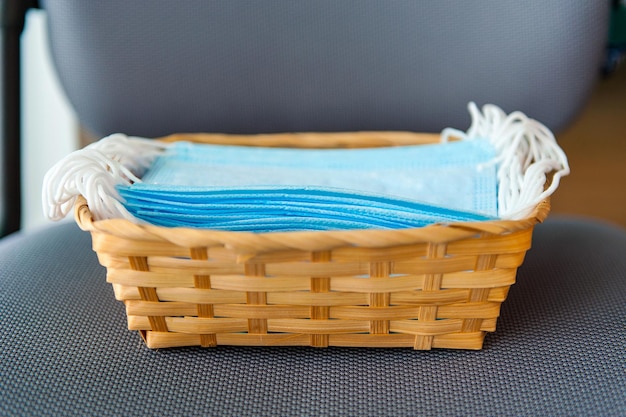 Medical sterile masks are in a basket in a pile