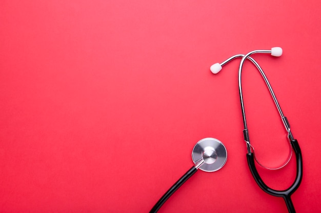 Medical stethoscope on red