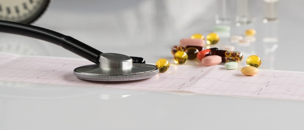 Medical stethoscope with tonometer and ecg on a light background