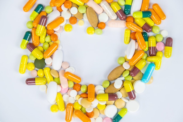 Medical supplies on a yellow background, pills water treatment mask virus. Selective focus