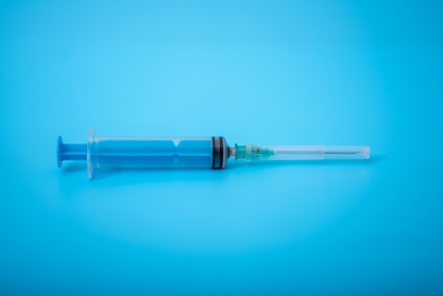 Medical syringe on blue background The concept of science and research