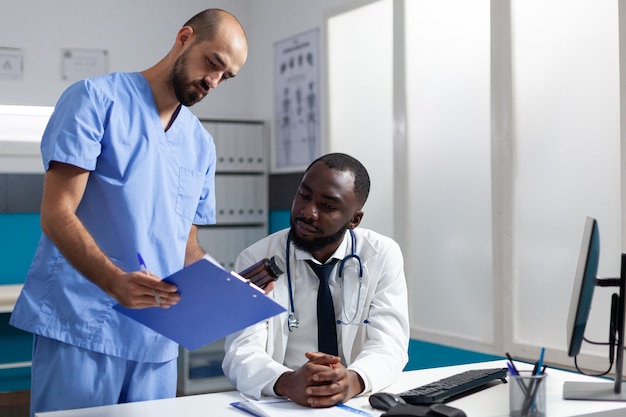 Medical team analyzing disease symptoms discussing healthcare treatment