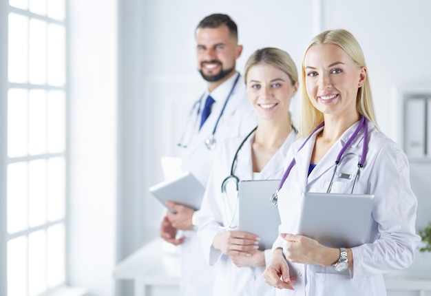 A medical team of doctors man and women isolated on white background