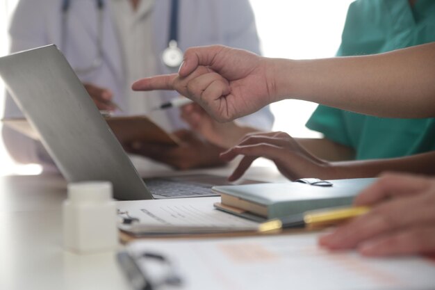 Medical Team Meeting Around Table In Modern Hospital