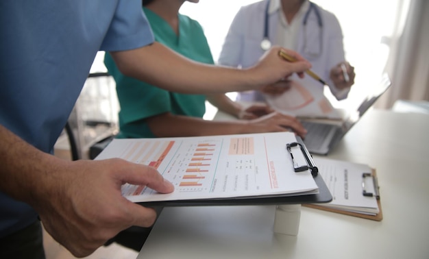 Medical Team Meeting Around Table In Modern Hospital