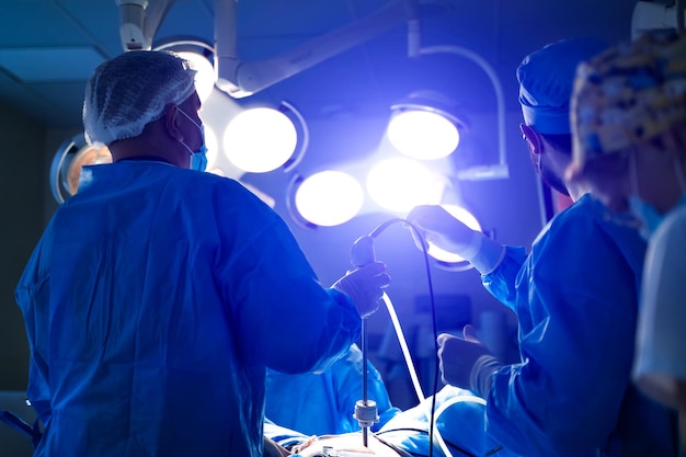 Medical team performing surgical operation in bright modern surgery room Operating theatre Modern equipment in clinic Emergency room