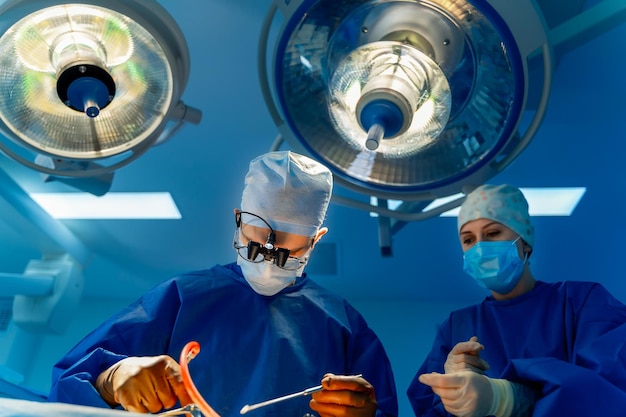 Medical team performing surgical operation in modern operating room