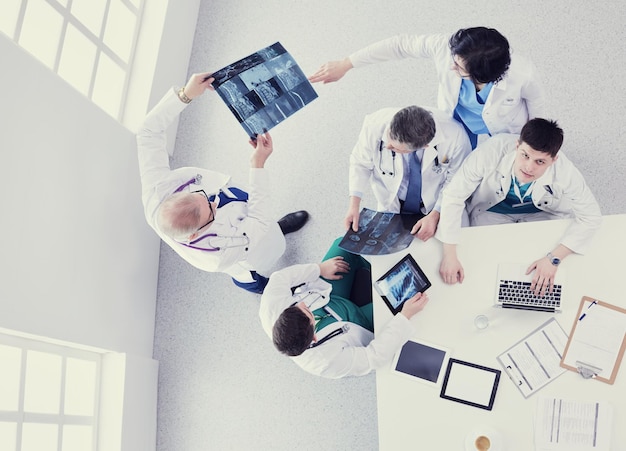 Medical team sitting and discussing at table top view