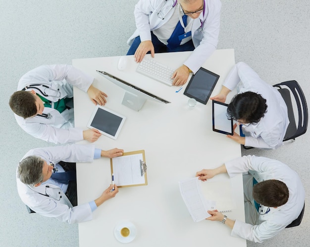 Medical team sitting and discussing at table top view