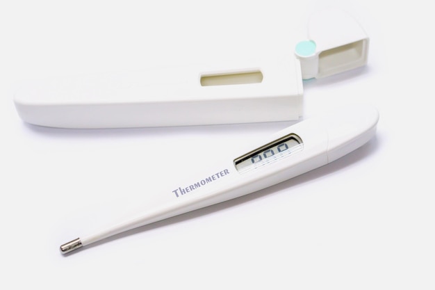 Medical thermometer and casing on white background