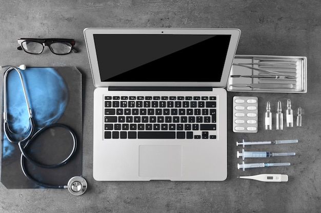 Photo medical tools set with laptop on dark gray background