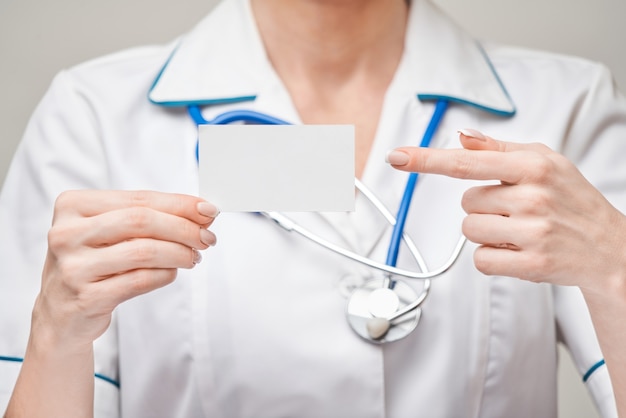 Medical worker doctor or nurse showing blank business card