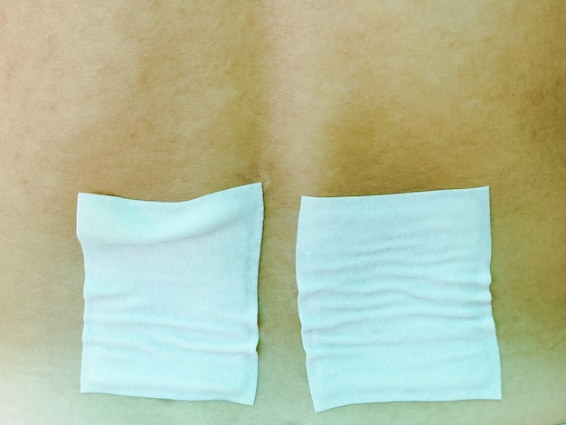 Medicated pain relief patch, plaster. man with back pain. Pain relief and health care concept