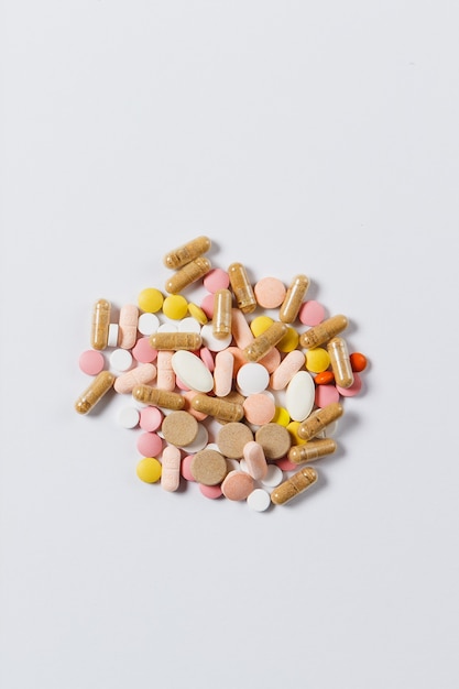 Medication colorful round tablets arranged abstract on white color background