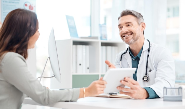 Medication isnt always necessary but belief in recovery always is Shot of a mature doctor using a digital tablet during a consultation with a patient in a medical office