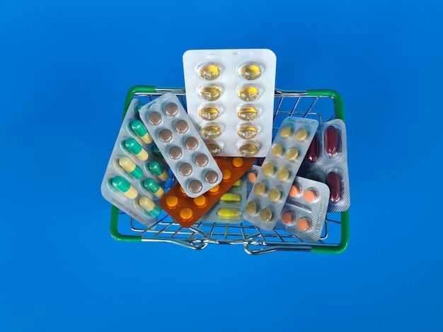 Medicinal pills and vitamins in a small shopping cart in supermarket