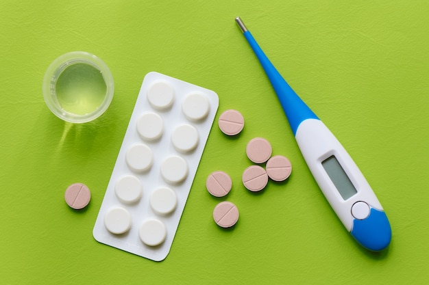 Medicinal preparations, pills, thermometer and measuring cup