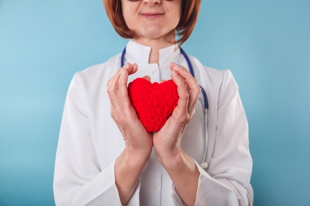 Medicine doctor holding red heart in hands