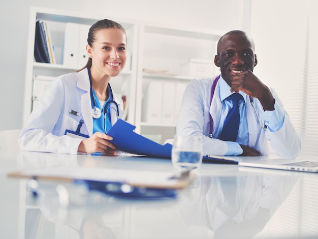 Medicine doctor offering hand to shake in office closeup Doctors