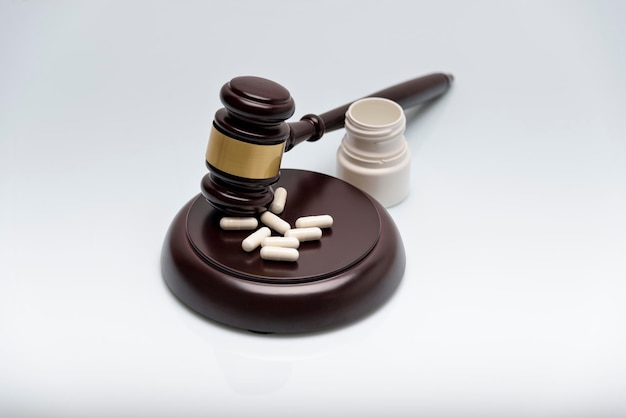 Medicine law concept Gavel stethoscope and pills isolated on white