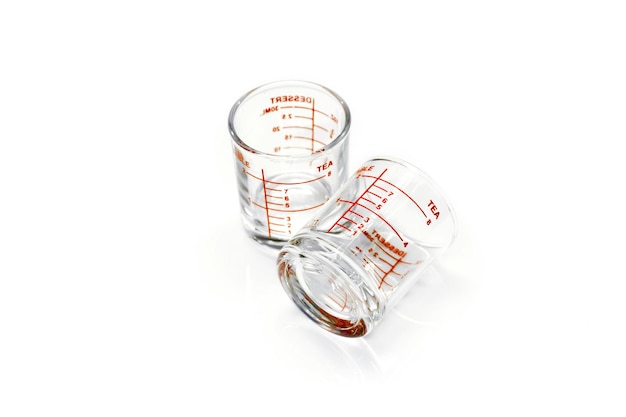 Medicine measuring glass cups isolate on white background