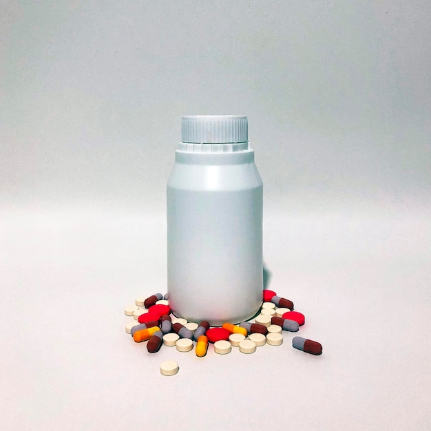 Medicine Pills or Tablets Drop and Out of the White Plastic Bottle.